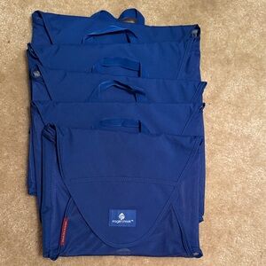 Eagle Creek Blue Packing Cubes Set of 5. Measures 9 inches by 12 inches
